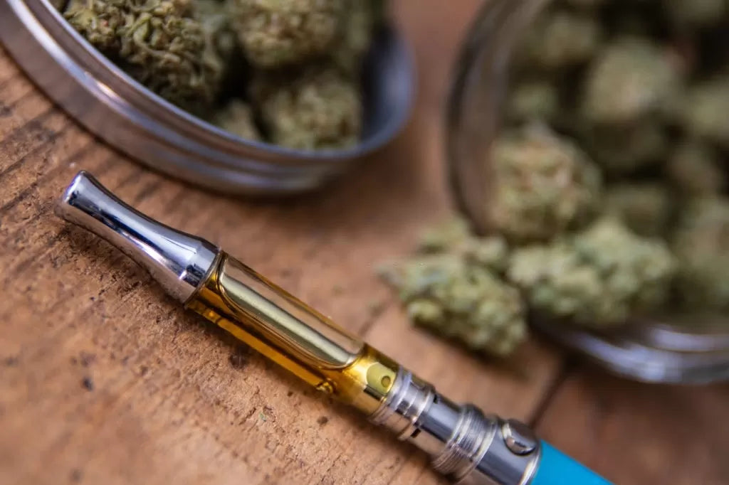 CBG Vape Cartridge next to CBG flower nugs