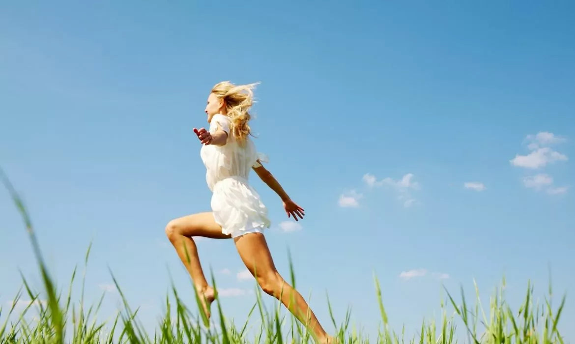 Woman filled with energy running in an open field