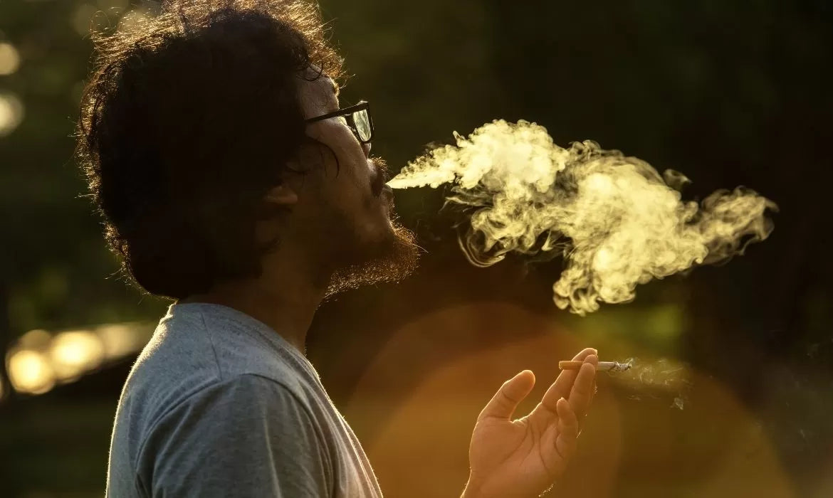 Person smoking the best strain for muscle relaxation