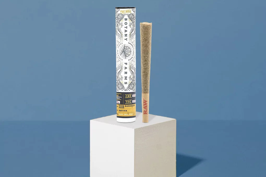 A pre-roll of Botany Farms sour Hawaiian haze sits on a pedestal, presenting the best weed for masturbating
