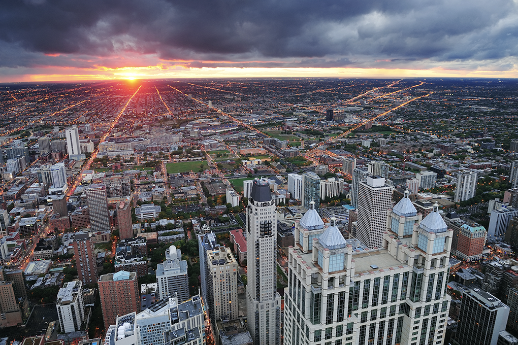 Stunning sunset over Michigan, 900 North Michigan Shops amidst diverse skyline of small and highrise buildings