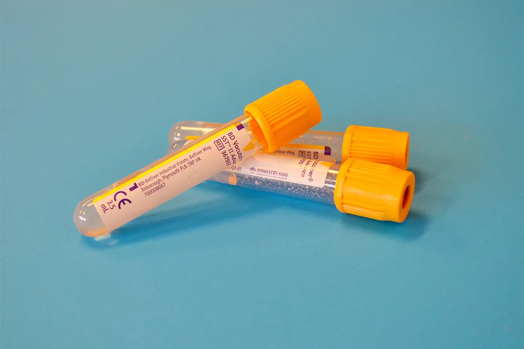 Three drug test tubes lay on top of each other against a blue background.