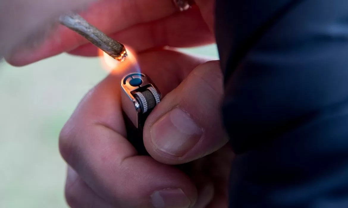 Person lighting a CBG joint
