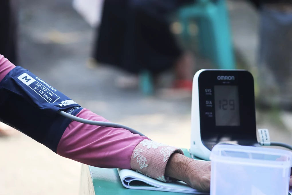 A photo of a persons arm strapped into a monitor to measure blood pressure.