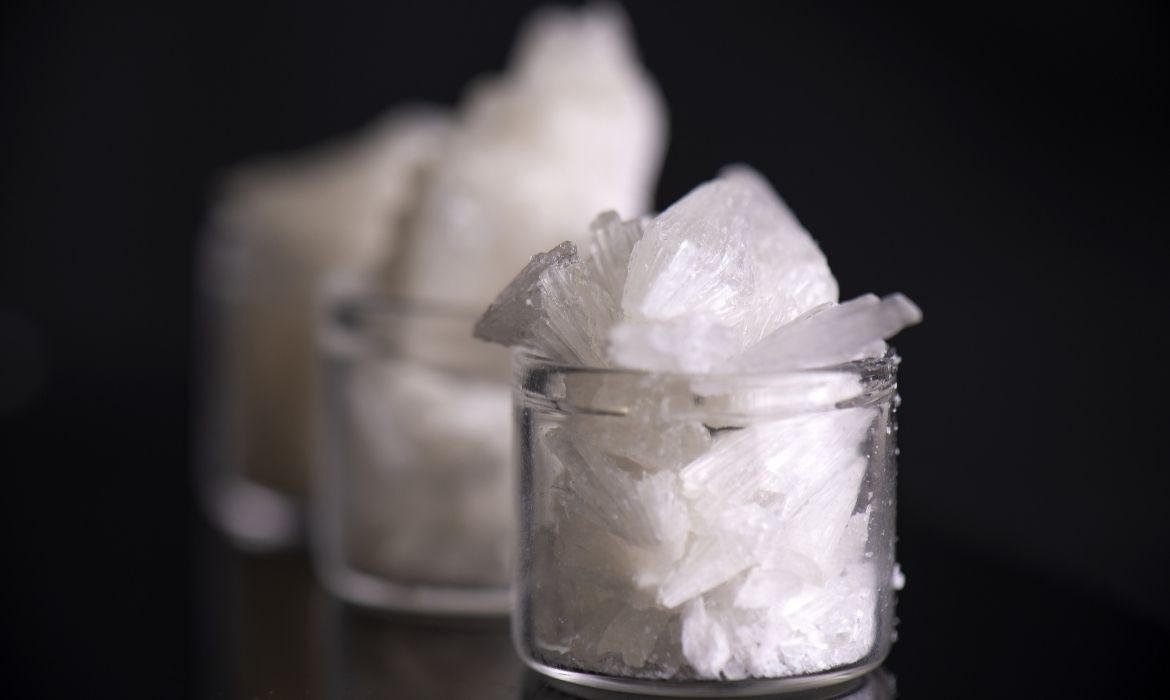 Close up to small jars full of CBD isolate