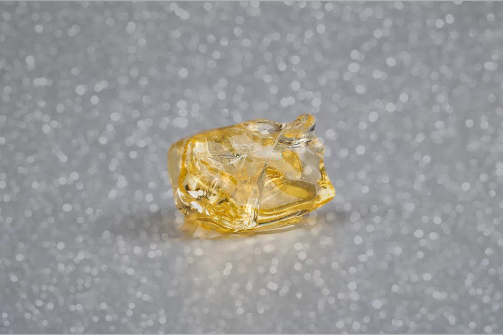 Yellow cannabis diamond on a grey surface