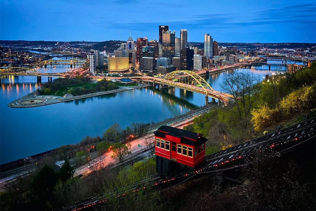 An evening cityscape of Pennsylvania surrounding the Fort Pitt Bridge