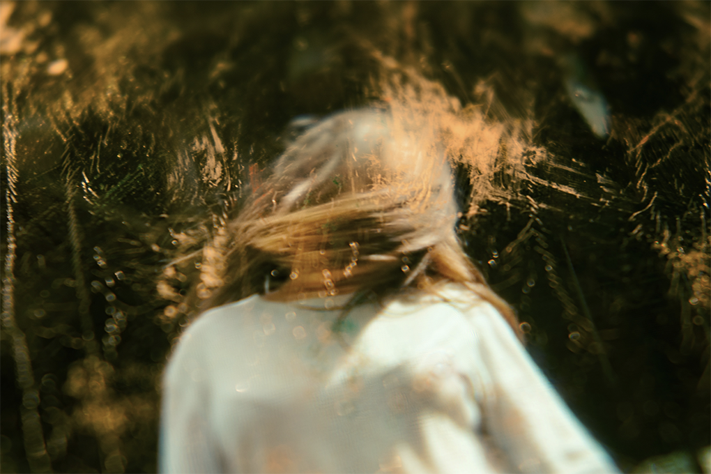 An A.I. generated, blurry, image of a person whipping their hair back and forth.