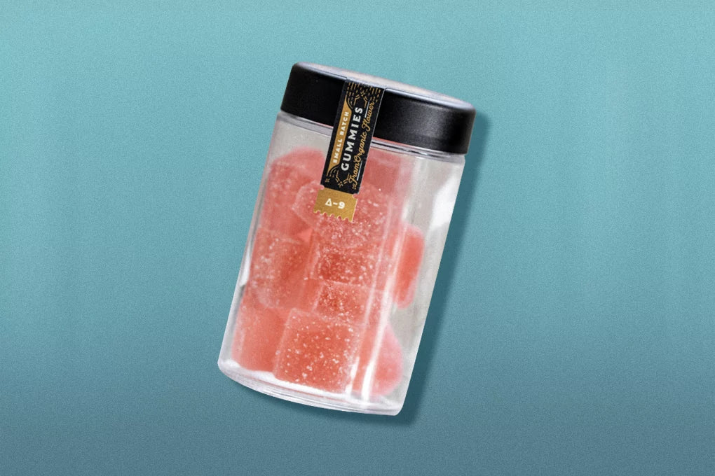 A jar of Botany Farms micro dose Delta-9 THC gummies float in front of a solid blue backdrop.