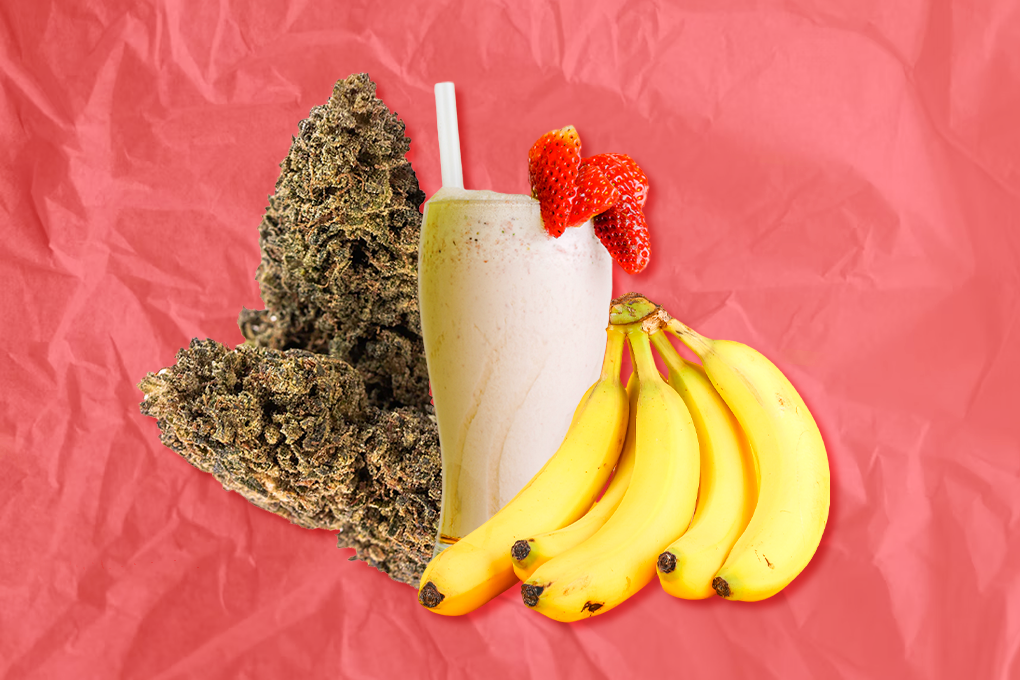 A glass of milkshake with strawberries in it, accompanied by sliced bananas and a cannabis strain, placed next to the glass against a peach-colored background