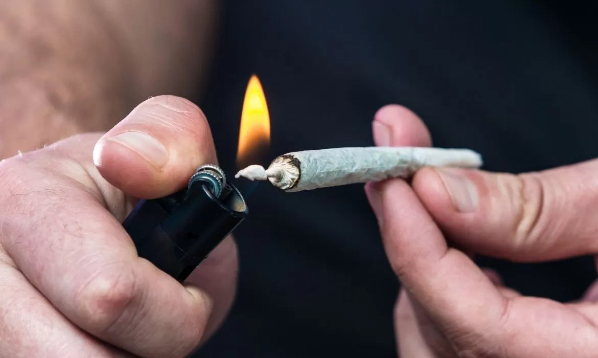 Person lighting a Delta 8 blunt