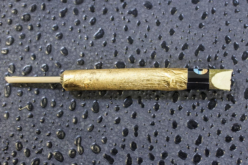 A cannagar sits on a flat surface among water droplets