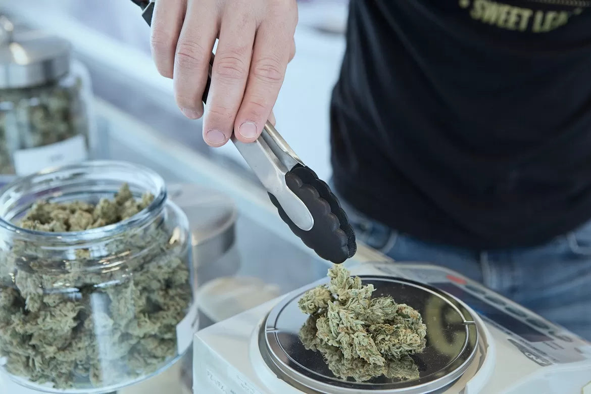 An online cannabis dispensary weighing and fulfilling an order
