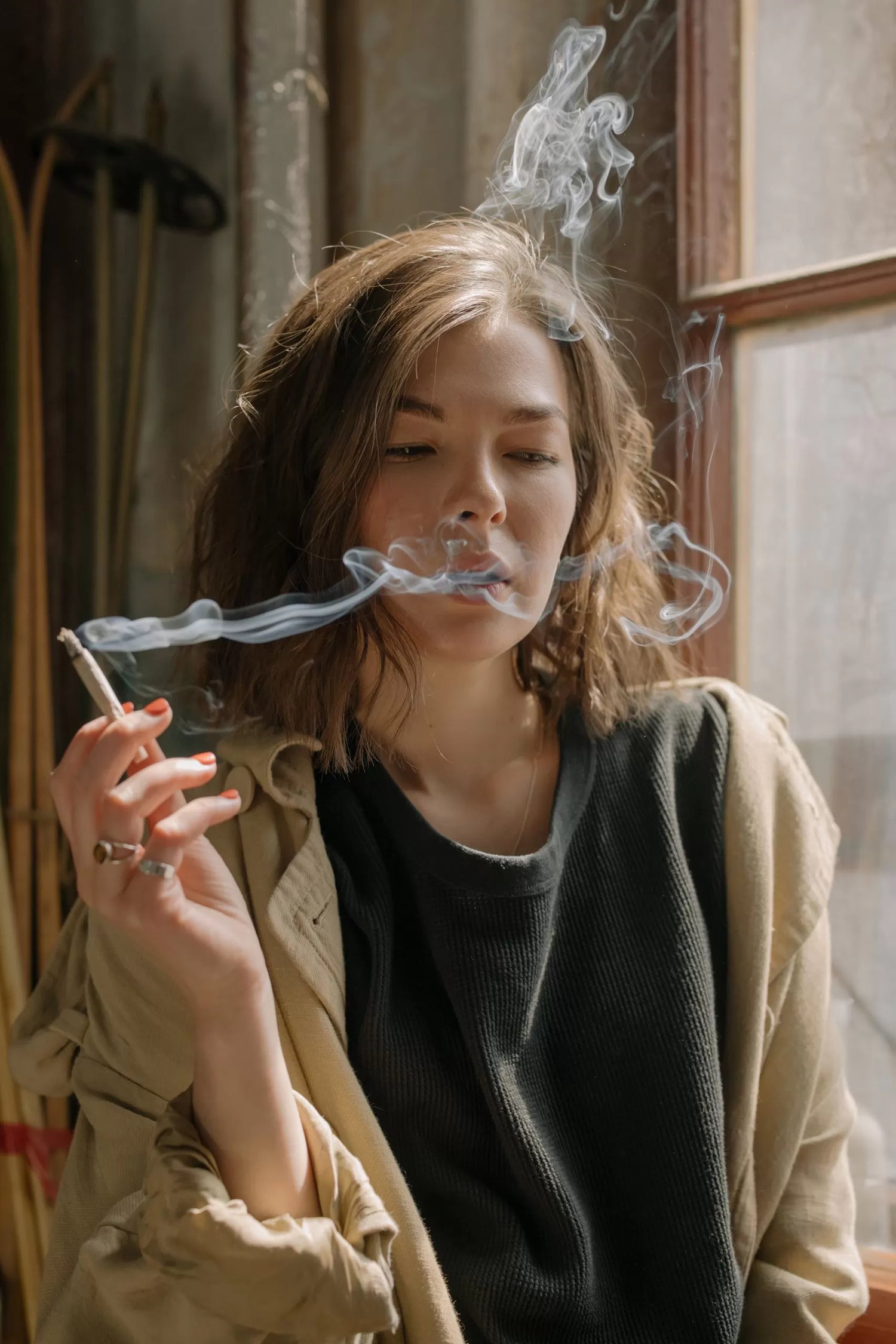 A woman smoking a hemp flower joint
