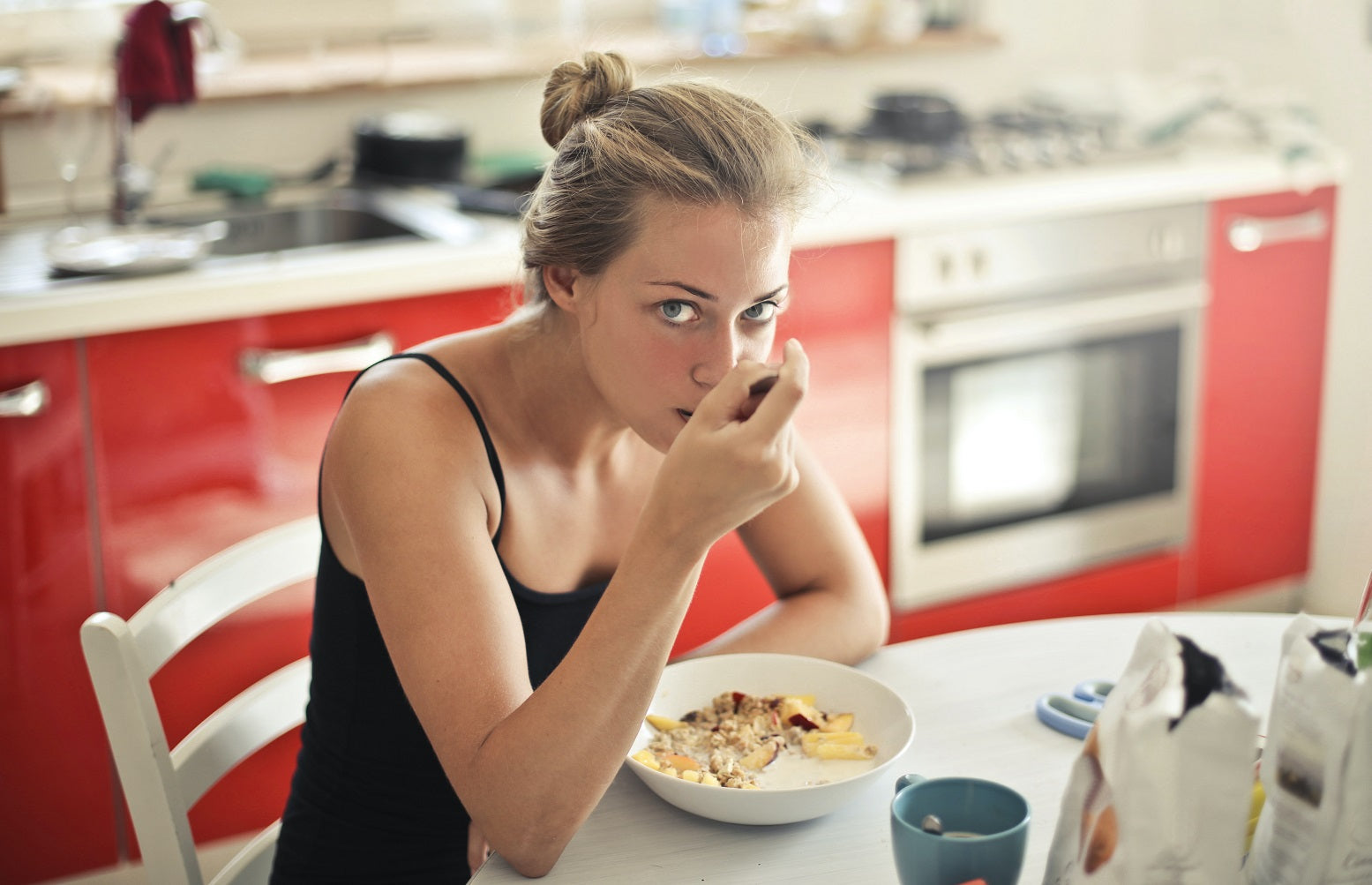 A woman eating a bowl of Hemp Granola